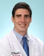 Portrait of Andrew Sloan, MD, in his lab coat.