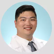 Photo of Dr. Alex Gu in white lab coat