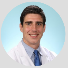 Portrait of Dr. Andrew Sloan in his lab coat.